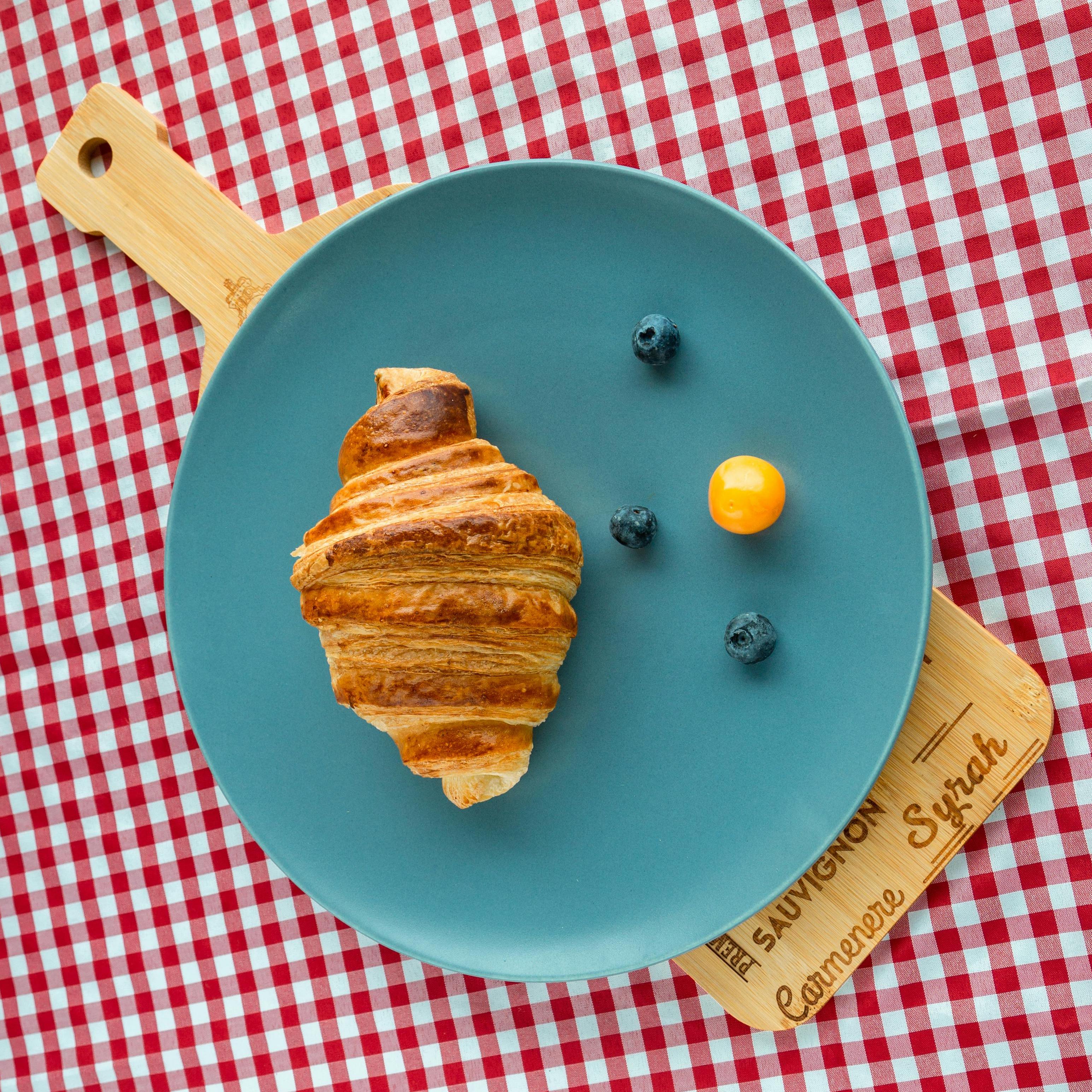 croissant on a plate with fruit